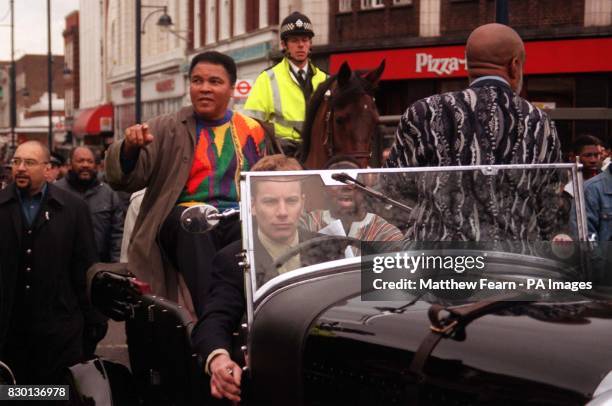 Boxing legend Muhammad Ali rides through Brixton, London in a classic open-top car. His visit was in support of the Jubilee 2000 Coalition which is...