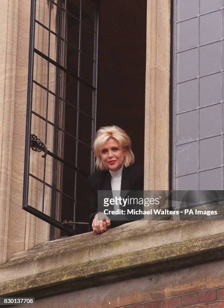 Gennifer Flowers, who had an infamous liaison with US President Bill Clinton, smiles from a window at Oxford University , where she will warn female...