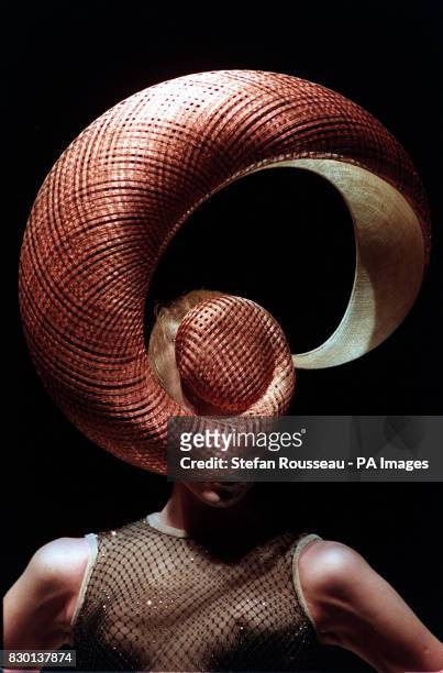 Model presents an elaborate hat created by designer Philip Treacy, during his London Fashion Week show.