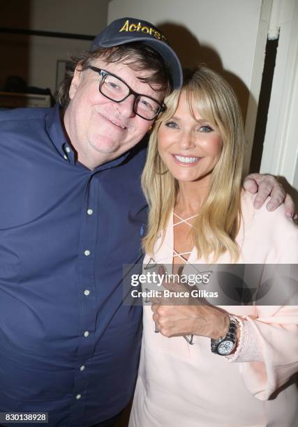 Michael Moore and Christie Brinkley pose backstage at the opening night of "Michael Moore: "The Terms Of My Surrender" on Broadway at The Belasco...