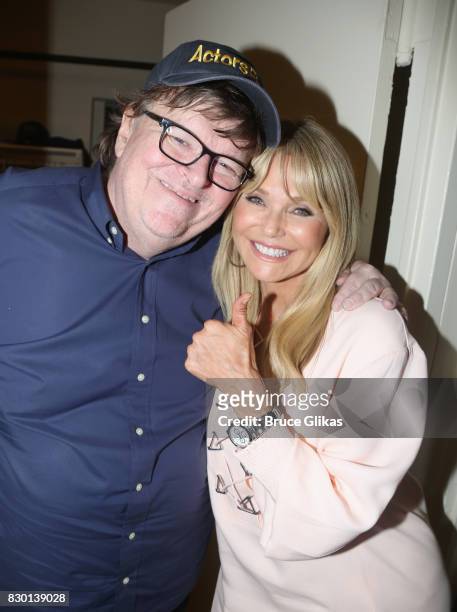 Michael Moore and Christie Brinkley pose backstage at the opening night of "Michael Moore: "The Terms Of My Surrender" on Broadway at The Belasco...