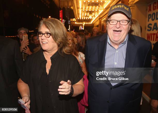 Rosie O'Donnell and Michael Moore walk in a parade of celebration to the opening night party for "Michael Moore: "The Terms Of My Surrender" on...