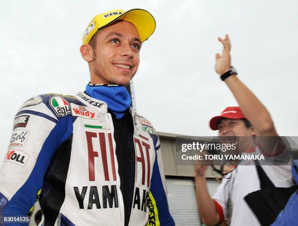 Japanese fan cheers on Italian rider Valentino Rossi before the free practice for the MotoGP Japanese Grand Prix at the Motegi Circuit in Motegi on...