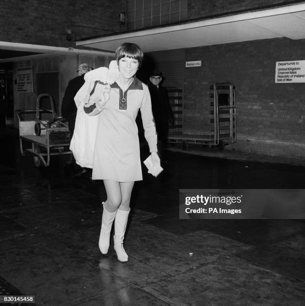 Fashion designer Mary Quant at London Airport to travel to Amsterdam to judge a mini skirt competition.