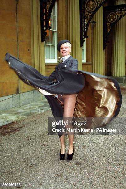 VIVIENNE WESTWOOD FASHION DESIGNER AT BUCKINGHAM PALACE WHERE SHE RECEIVED HER OBE FROM THE QUEEN, BUT BENEATH HER RESPECTABLE TAILORED SUIT SHE WORE...