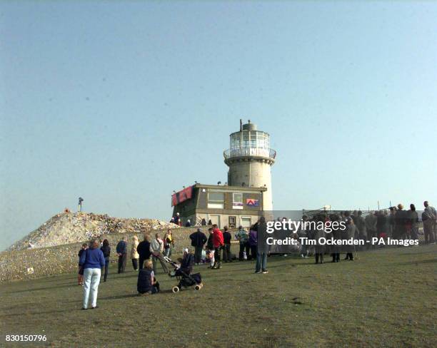 Crowds of sight seers watch as the Belle Tout Lighthouse at Beachy Head in East Sussex is moved slowly toward its new site. The granite lighthouse...
