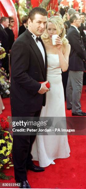 American actor Alec Baldwin with his wife, actress Kim Basinger, at the Dorothy Chandler Pavilion in Los Angeles for the 71st annual Academy Awards....