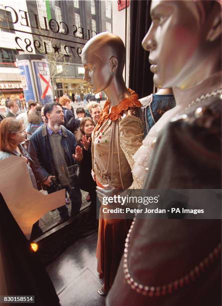Shoppers in London's Oxford Street view the original costumes worn by Abba on the night the group won the 1974 Eurovision Song Contest, on display at...