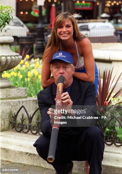 Chris Tarrant playing a didgeridoo with Mimi MacPherson, younger sister of Australian supermodel Elle, at the launch of Fostralia 2000, in London....