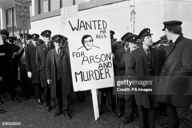 Banner carrying a portrait of Home Secretary Merlyn Rees and the words "Wanted for Arson and Murder" depicts the mood of this group of striking...