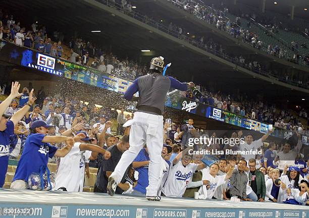 Angel Berroa of the Los Angeles Dodgers celebrates with the fans after clinching the National League West title after the game against the San Diego...