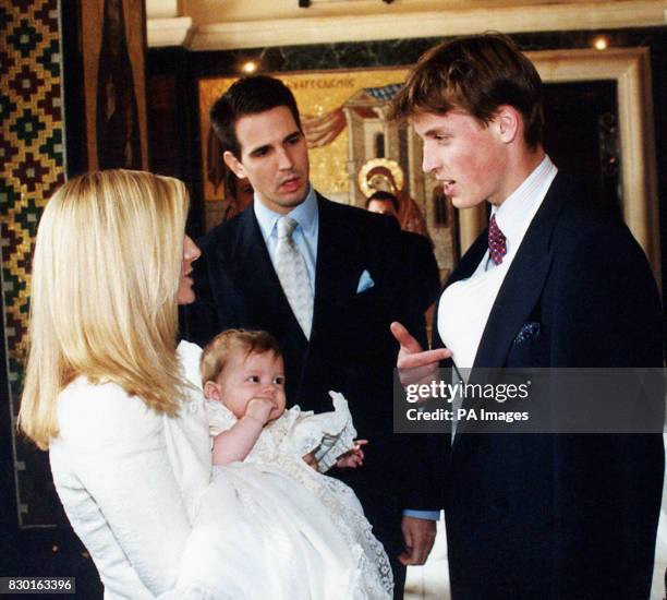 Prince William, right, older son of the Prince of Wales, talks to Crown Prince and Princess Pavlos, after the christening of their son, Prince...