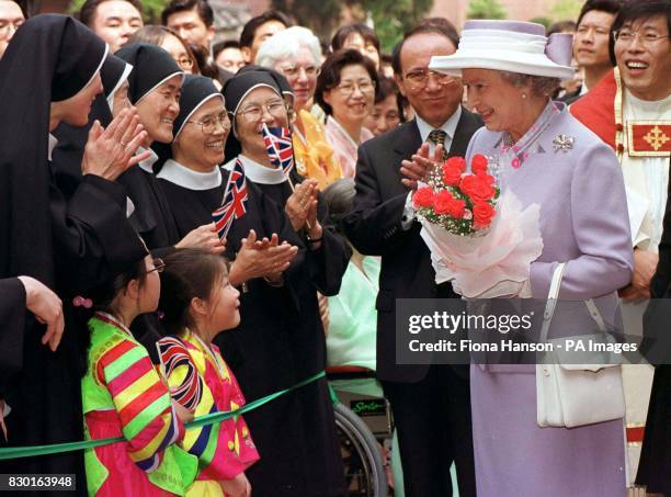 The Queen meets nuns outside the Anglican Cathedral in Seoul, on the last day of her state visit to South Korea.