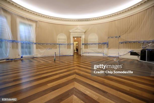 The Oval Office sits empty and the walls covered with plastic sheeting during renovation work at the White House August 11, 2017 in Washington, DC....