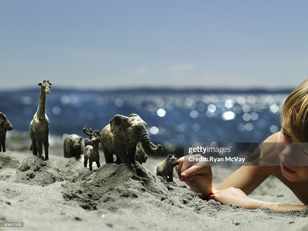 Boy building sand animals