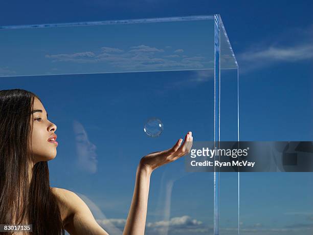 woman catching bubble in hand - spazio circoscritto foto e immagini stock