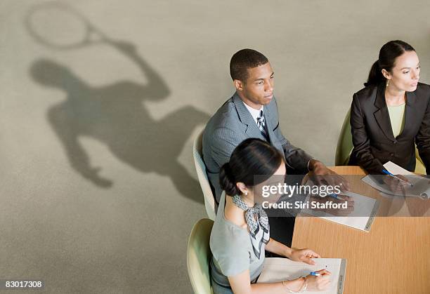 office workers with revealing shadows - job shadow stock pictures, royalty-free photos & images