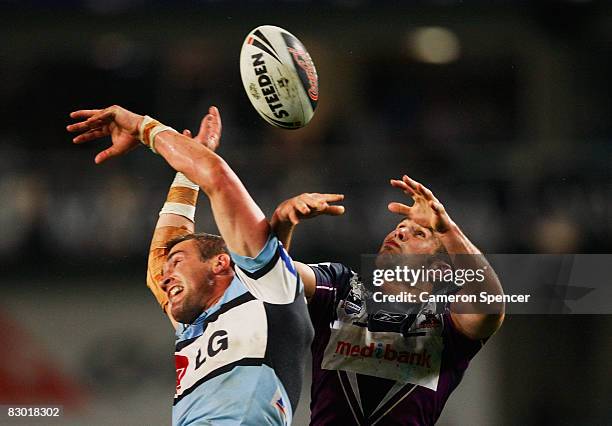 Luke Covell of the Sharks and Steve Turner of the Storm contest a high ball during the first NRL Preliminary Final match between the Cronulla Sharks...