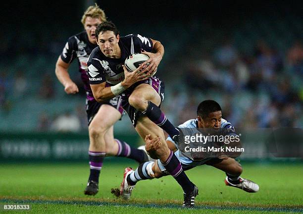 Billy Slater of the Storm breaks the tackle of Terence Seu Seu of the Sharks to set up a try for Matt Geyer during the first NRL Preliminary Final...