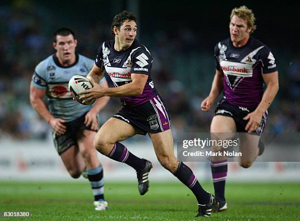 Billy Slater of the Storm makes a line break to set up a try for Matt Geyer during the first NRL Preliminary Final match between the Cronulla Sharks...