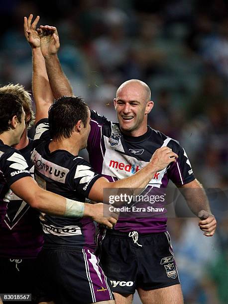 Matt Geyer of the Storm is congratulated by teammates after he scored a try during the first NRL Preliminary Final match between the Cronulla Sharks...