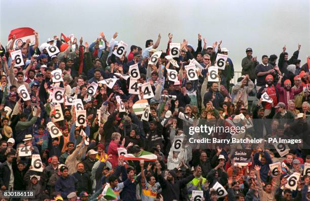 India's supporters celebrate a 6 from Sachin Tendulkar, as their team moves towards the massive total of 329 against Kenya in the Cricket World Cup...