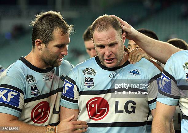 Adam Peek of the Sharks is comforted by teammates after losing the first NRL Preliminary Final match between the Cronulla Sharks and the Melbourne...