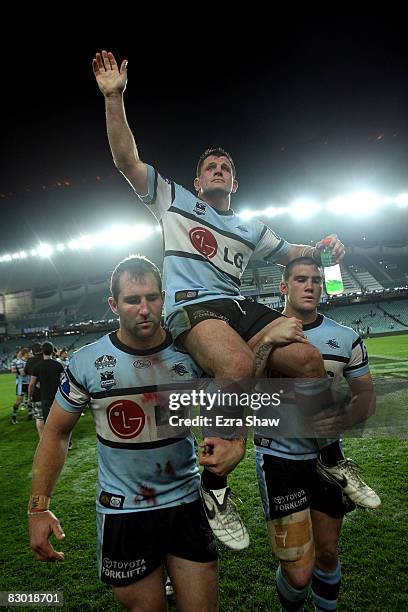 Danny Nutley of the Sharks is carried off the field after losing the first NRL Preliminary Final match between the Cronulla Sharks and the Melbourne...