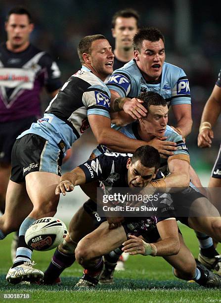 Greg Inglis of the Storm loses the ball when he is tackled by the Sharks during the first NRL Preliminary Final match between the Cronulla Sharks and...