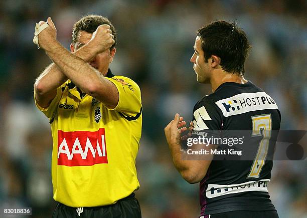 Referee Tony Archer places Brett White of the Storm on report for a lifting elbow on Ben Ross as Storm captain Cooper Cronk looks on during the first...