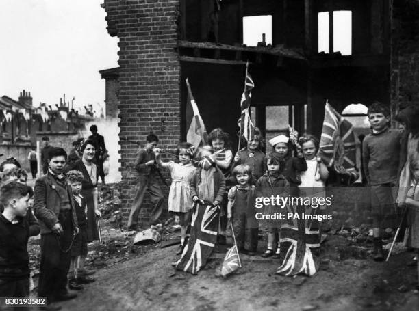 Young London residents celebrate VE-Day, marking the end of the war in Europe, amidst the ruins of their home in Battersea.