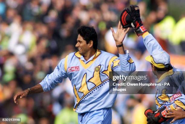 Indian wicketkeeper Nayan Mongia congratulates Venkatesh Prasad after Prasad claimed the wicket of Pakistan's Moin Khan during theirWorld Cup cricket...