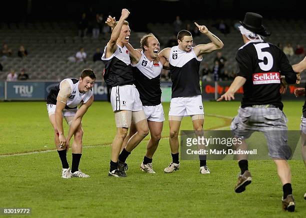 Tom Roach, Shaune Moloney, Marc Greig and Gavin Urquhart of the Roosters celebrate their win in the VFL Grand Final match between North Ballarat and...