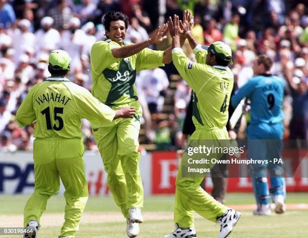 Pakistani pace bowler and captain Wasim Akram celebrates the wicket of New Zealand's Craig McMillan in their 1999 World Cup cricket semi-final match...