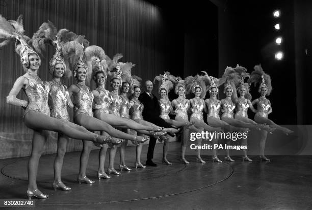 Impresario Robert Luff, flanked by the dancing troupe The Tiller Girls, on stage at the London Palladium. Mr Luff has taken over control of the...