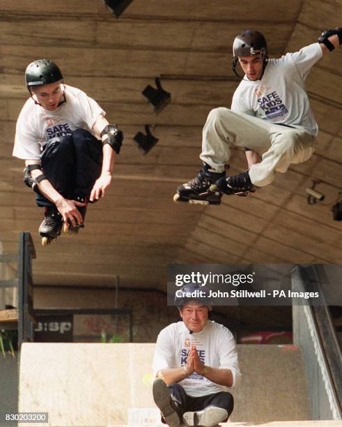 Rob Cole and Johnny Sao-Bento demonstrate their rollerblading skills by jumping over Sports minister Tony Banks, at the Sony Playstation Skate Park,...