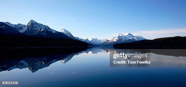 lake surrounded by mountains - symmetry nature stock pictures, royalty-free photos & images