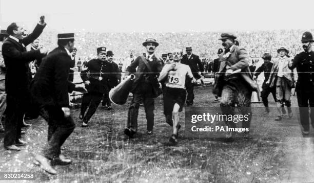Italian Dorando Pietri about to break the tape to win the 1908 London Olympic Marathon. Pietri was later disqualified for having been assisted by his...