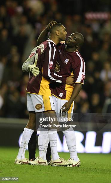 Leon Constantine of Northampton Town is consoled by team-mate Adebayo Akinfenwa after his miss in the penalty shoot out gave victory to Sunderland...