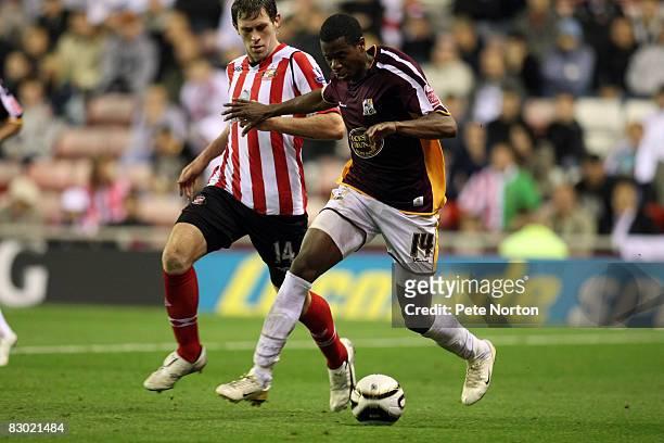 Liam Davis of Northampton Town shields the ball from Daryl Murphy of Sunderland during the Carling Cup Third Round Match between Sunderland and...
