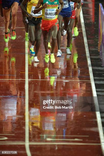 16th IAAF World Championships: Partial view of Ethopia Selemon Barega in action during Men's 5000M race at Olympic Stadium. Reflection of runners on...
