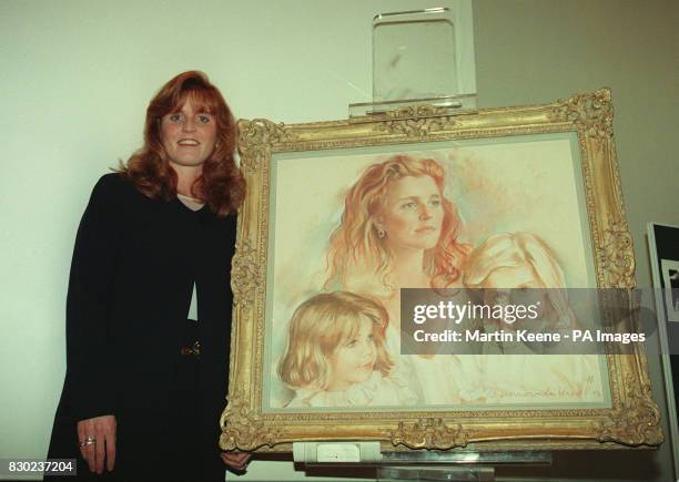 The Duchess of York , Sarah Ferguson, with a portrait of herself with the two Princesses, Beatrice and Eugenie, at the opening of an the 'Portraits...