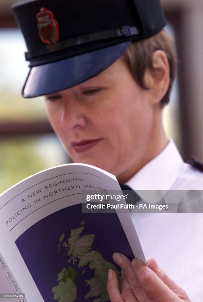 A female constable from the Royal Ulster Constabulary looks over the ...