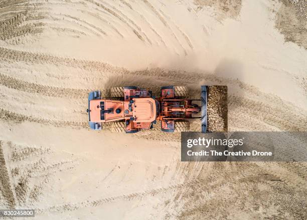 digger moving earth - mining stock pictures, royalty-free photos & images