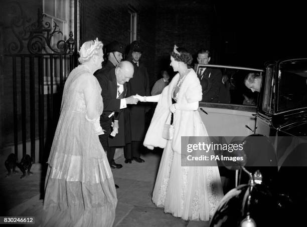 Watched by Lady Churchill, Prime Minister Sir Winston Churchill bows low to Queen Elizabeth II as he welcomes her and the Duke of Edinburgh to 10...