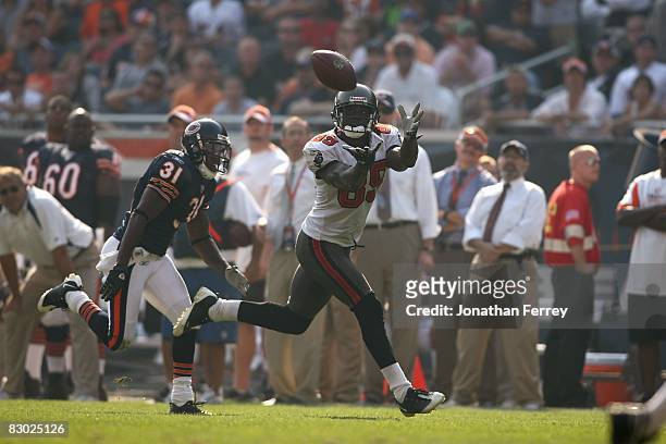 Antonio Bryant of the Tampa Bay Buccaneers catches the ball against Nathan Vasher of the Chicago Bears at Soldier Field on September 21, 2008 in...