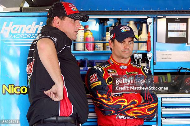 Crew chief Steve Letarte chats wih driver Jeff Gordon during practice for the NASCAR Sprint Cup Series Camping World RV 400 at Kansas Speedway on...