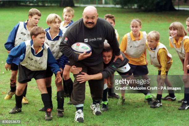 Former British Lion and England international Gareth Chilcott is tackled by former England women's rugby captain Gill Burns as they kick-off Lloyds...