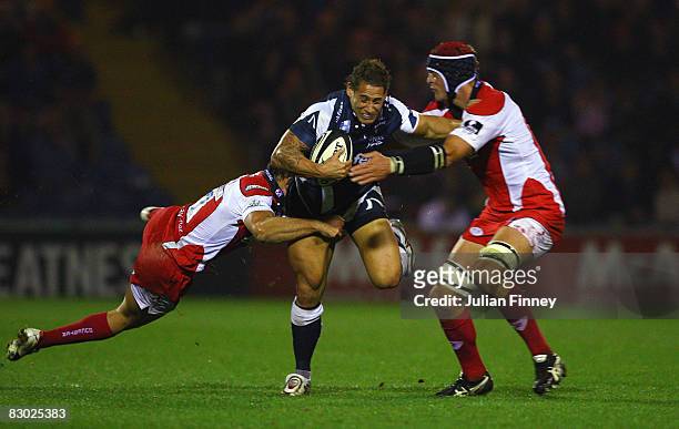 Luke McAlister of Sale is tackled by Olly Barclay and Alex Brown of Gloucester during the Guinness Premiership match between Sale and Gloucester at...
