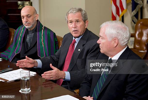 Afghan President Hamid Karzai, US President George W. Bush, and Secretary of Defense Robert Gates participate in a Video Teleconference with United...